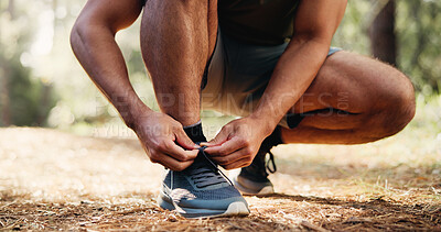 Buy stock photo Man, hands and tying with shoes in forest for fitness or workout preparation on hiking trail. Active, male person or runner getting ready with sneaker, tie or laces for trekking safety or exercise