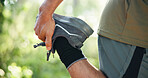 Man, hands and stretching with legs in forest for workout preparation, start or begin in nature. Closeup, male person or runner getting ready with warm up in woods for outdoor training or exercise