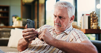 Buy stock photo Senior man, relax and phone at house for browsing website, social media and message update. Elderly person, reading and mobile app for subscription, download games and notification for online texting