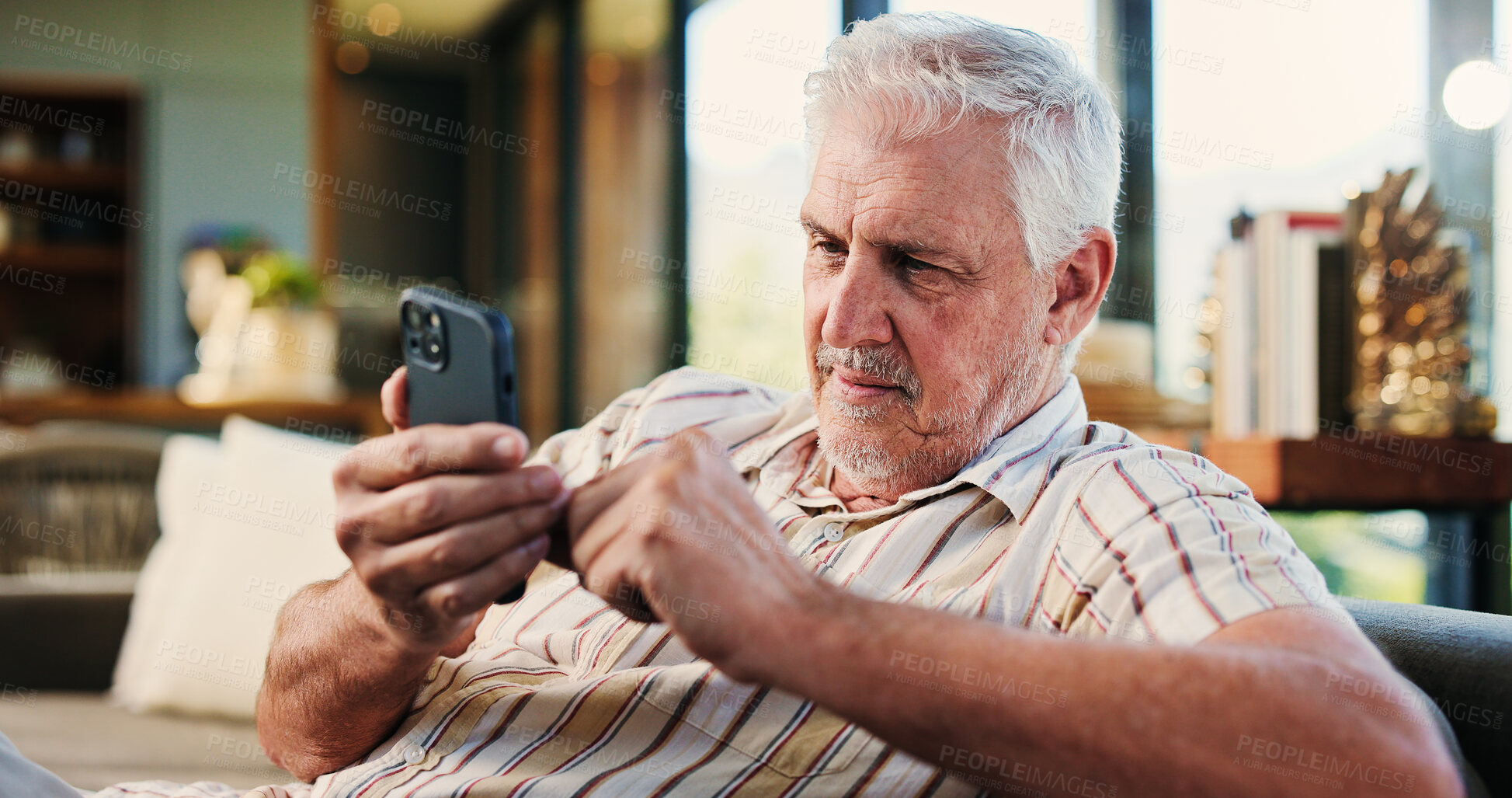 Buy stock photo Senior man, relax and phone at house for browsing website, social media and message update. Elderly person, reading and mobile app for subscription, download games and notification for online texting