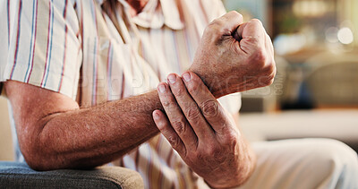 Buy stock photo Hand, wrist pain and senior man on sofa in home with arthritis, osteoporosis or carpal tunnel. Fibromyalgia, medical emergency and elderly male person with muscle sprain, tension or ache in house.