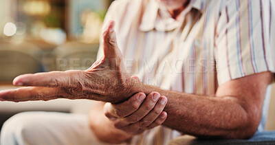 Buy stock photo Arthritis, wrist pain and senior man on sofa in home with fibromyalgia, osteoporosis or carpal tunnel. Hand, medical emergency and elderly male person with muscle sprain, tension or ache in house.