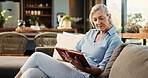 Reading, book and mature woman in house with hobby, calm and literature insight on weekend rest. Free time, knowledge or senior person with novel, relax and information guide on Saturday afternoon.