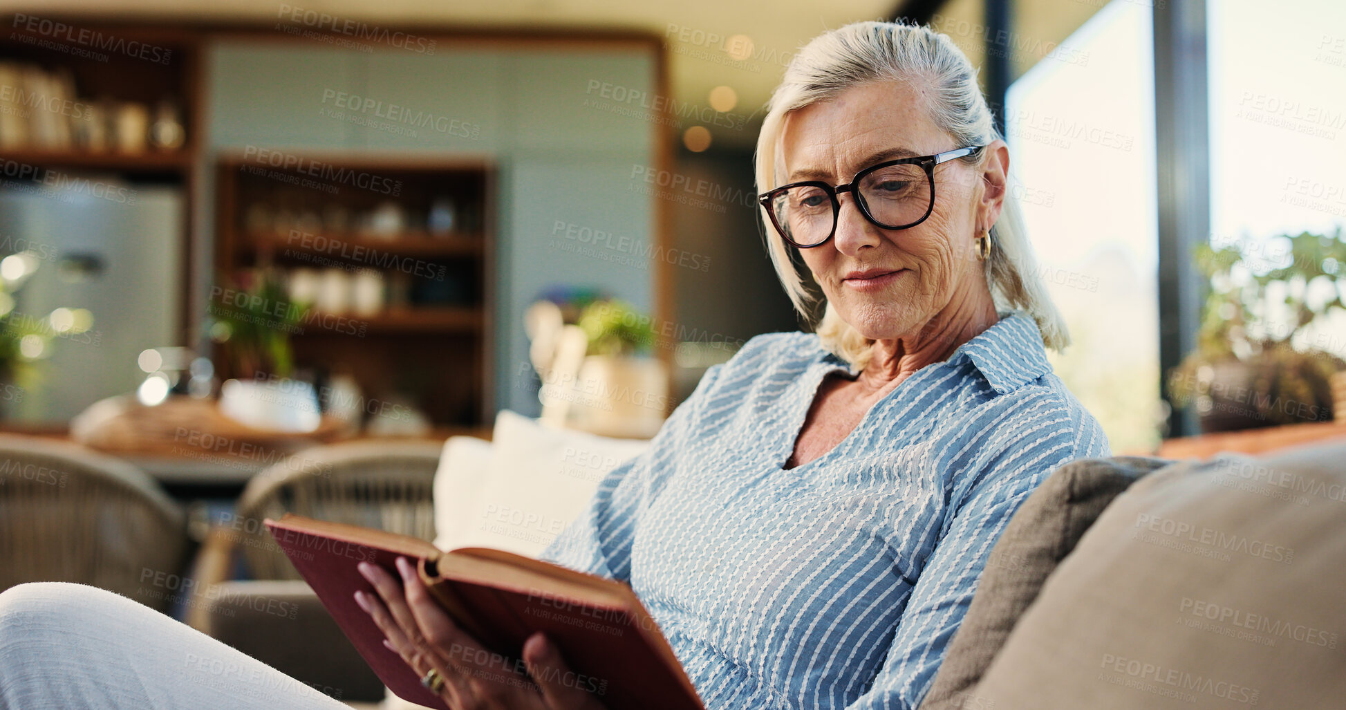 Buy stock photo Reading, book and senior woman on sofa with glasses, calm and literature hobby on weekend rest. Free time, peace and mature person in house with specs, relax and fantasy story on Sunday afternoon.