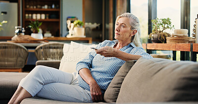 Buy stock photo Senior woman, watching tv and remote on couch, search and click for movie choice in retirement at house. Elderly person, television show and relax on sofa with streaming, film or subscription in home