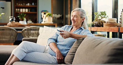 Buy stock photo Old woman, watching tv and remote on couch, happy or click for movie choice in retirement at house. Elderly person, television show and relax on sofa for streaming, comedy film and laugh at apartment