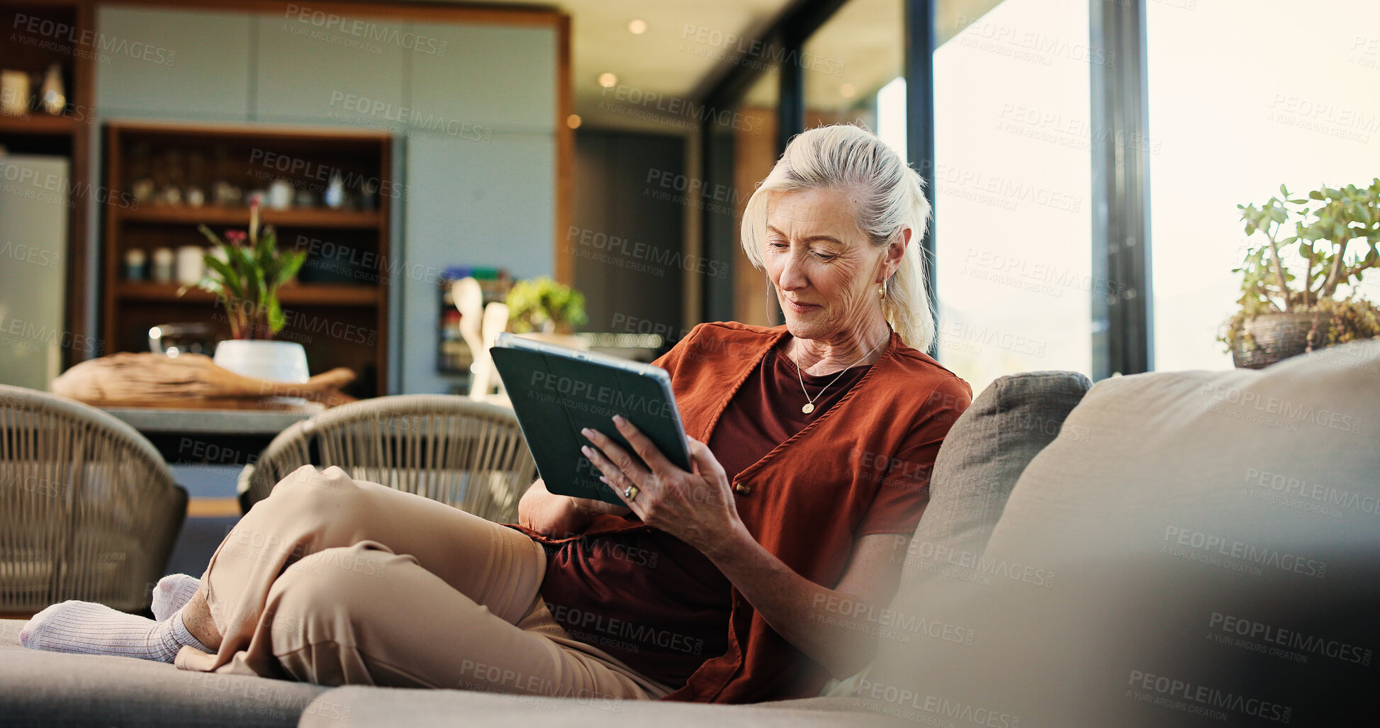 Buy stock photo Happy, woman and chill with tablet, lounge and watching videos on social media and app subscription. Online, entertainment and mature person with tech for movies, home and streaming series on website