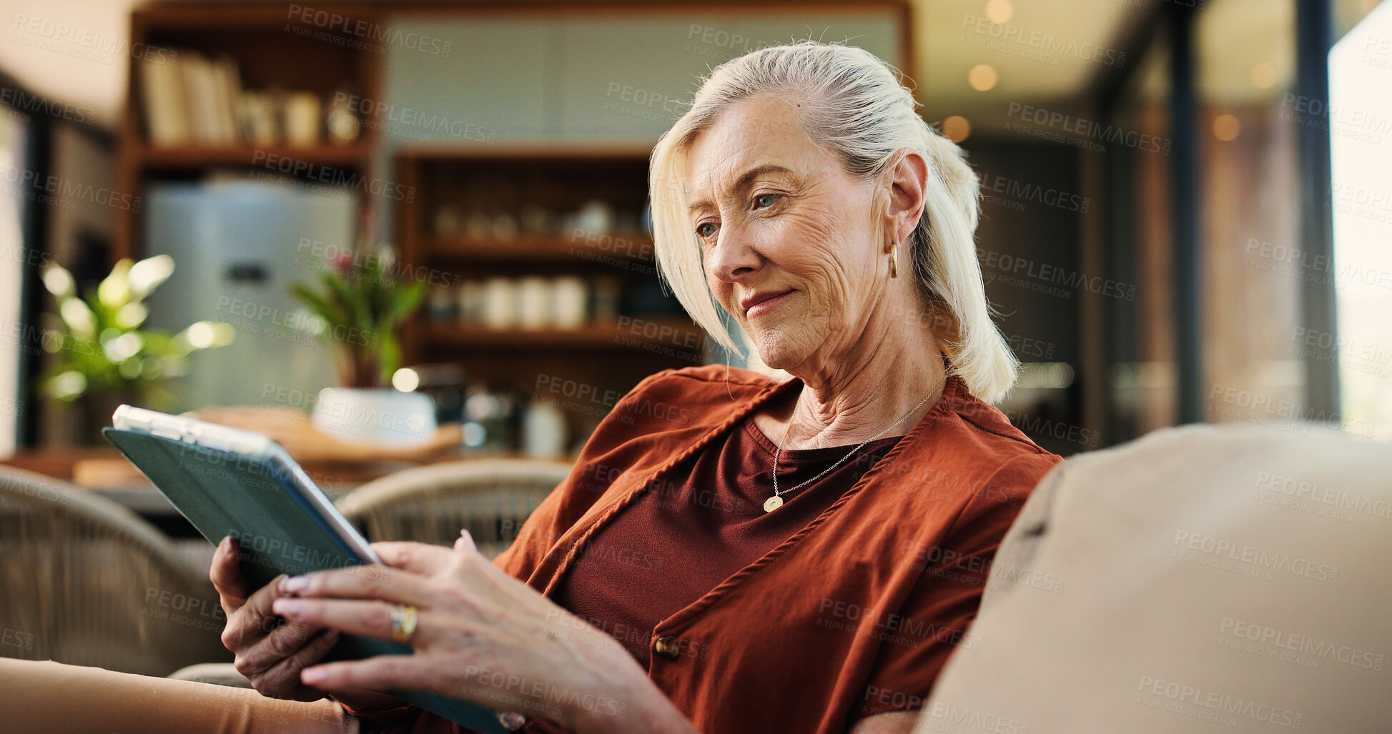 Buy stock photo Senior woman, tablet and happy on sofa, relax and streaming service for movies in living room at home. Person, tech and smile with app, video or film subscription on web, couch or scroll at apartment