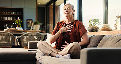 Buy stock photo Breathing, health and senior woman on sofa in home with balance, calm or zen practice in living room. Meditation, healing and elderly female person with grounding ritual for relax in apartment.