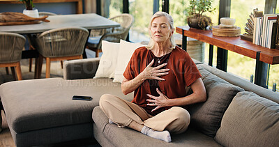 Buy stock photo Breathe, meditation and senior woman on sofa in home with balance, calm or zen practice in living room. Health, healing and elderly female person with grounding ritual for relax in apartment.