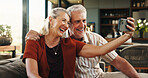 Senior, happy couple and hug with selfie for photography, memory or anniversary picture in home. Elderly, man and woman with smile or love for capture moment, embrace or bonding together in house