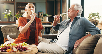 Buy stock photo Senior couple, champagne and location with drink for anniversary celebration or date in home. Elderly, man and woman with alcohol or charcuterie on sofa for valentines day or relationship in house