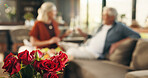 Anniversary, roses and senior couple on couch for romantic date, affection and marriage commitment. Love, loyalty and old people with champagne cheers in home for special day, celebration and flowers