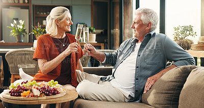 Buy stock photo Elderly, happy couple and cheers with champagne for anniversary celebration or date in home. Senior, man and woman with alcohol, fruit or charcuterie board for valentines day or romance in house