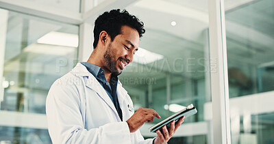 Buy stock photo Man, doctor and smile with tablet in hospital for research, medical report and confirm surgery. Male surgeon, digital and browsing website for Telehealth, healthcare results and treatment information