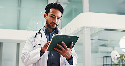 Buy stock photo Man, surgeon and reading with tablet in hospital for research, medical report and confirm surgery. Male doctor, digital and review website for Telehealth, healthcare results and treatment information