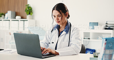 Buy stock photo Doctor, woman and typing with laptop at office for telehealth, notification or contact patient at clinic. Person, healthcare professional and computer with report, research or feedback at hospital