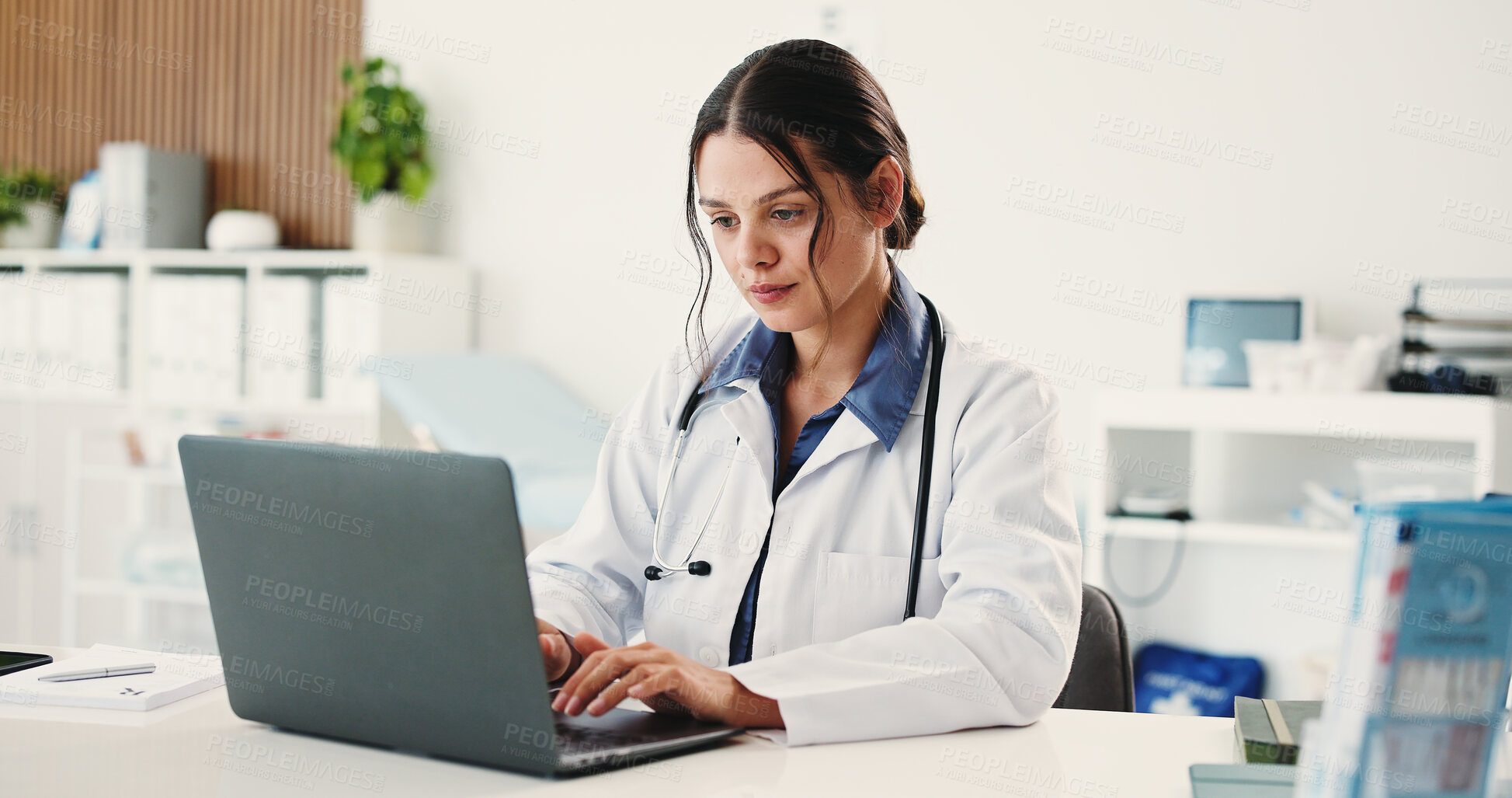 Buy stock photo Doctor, woman and typing with laptop at office for telehealth, notification or contact patient at clinic. Person, healthcare professional and computer with report, research or feedback at hospital