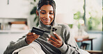 Home, smartphone and woman on sofa, credit card and digital app for online banking. Apartment, cellphone and happy person on couch, transactions or website for subscription payment, smile or purchase