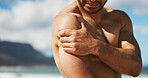 Hand, shoulder pain and man at beach with tension, inflammation or stiff joint with fibromyalgia. Topless male person, space with pressure or spasm of muscle ache, injury or body burnout outdoor