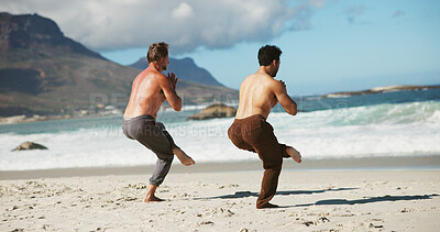 Buy stock photo Fitness, coach or men at beach with yoga, guidance and balance in wellness activity. Exercise, eagle pose or people at ocean with instructor, zen and mobility improvement in holistic practice.