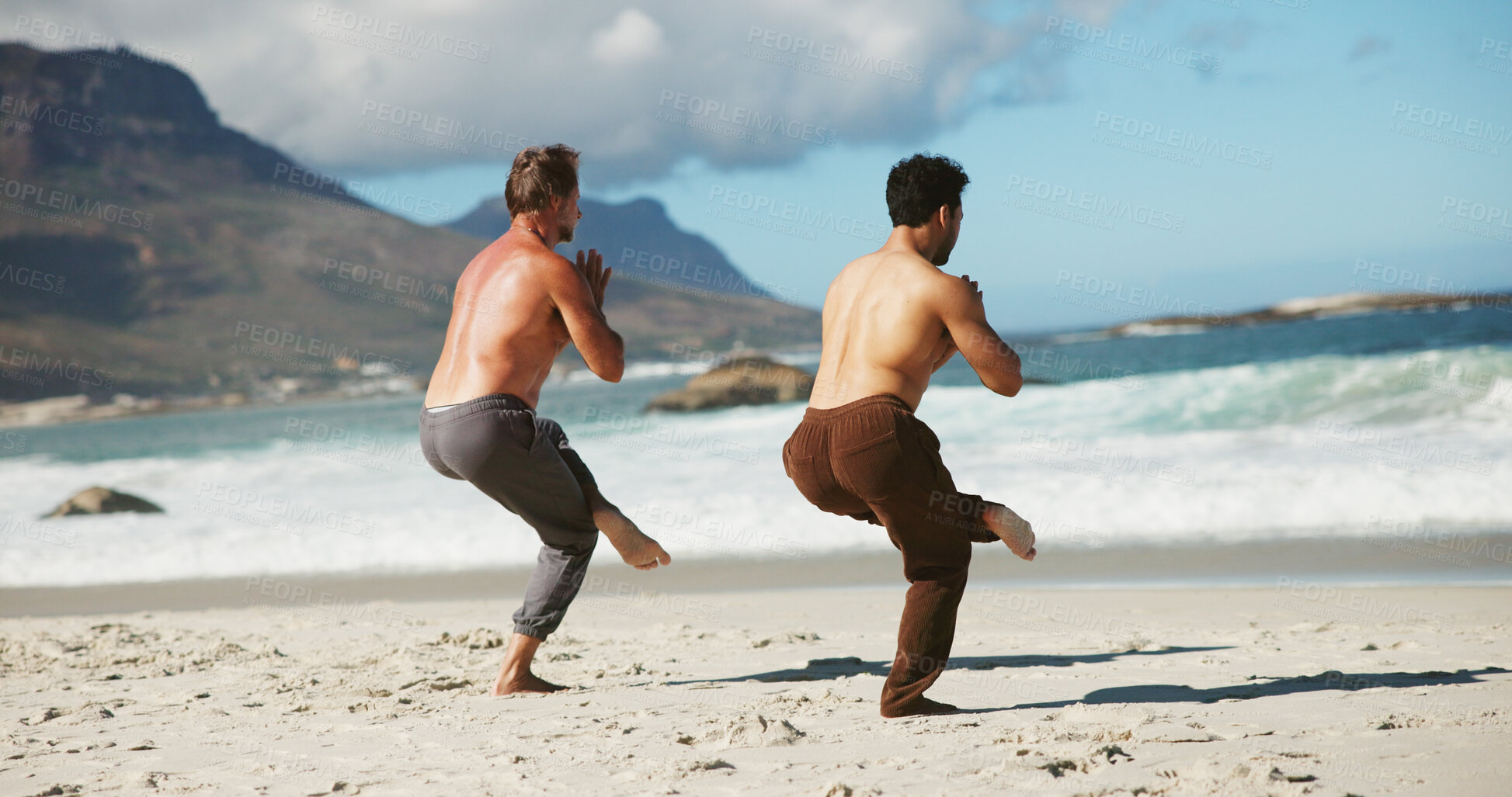 Buy stock photo Fitness, coach or men at beach with yoga, guidance and balance in wellness activity. Exercise, eagle pose or people at ocean with instructor, zen and mobility improvement in holistic practice.