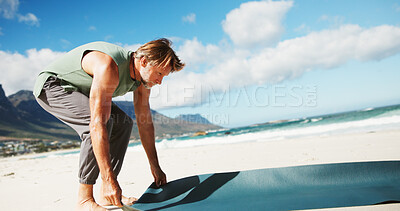 Buy stock photo Mature, man and yoga mat at beach for fitness, ready or start exercise for health, fresh air and routine in nature. Male person, equipment and prepare for pilates for holistic activity by ocean coast