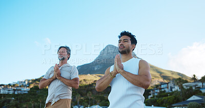Buy stock photo Men, prayer and meditation for mindfulness, beach and routine for peace, low angle and stress relief. Outdoor, space and people with spiritual awareness in nature, namaste and faith for wellness