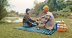 Happy, couple and picnic with coffee outdoor for travel, warm beverage and trekking adventure. Smile, people and camping with drink for breakfast, romance and bonding together on holiday in nature