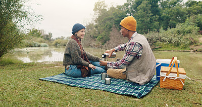 Buy stock photo Happy, couple and picnic with coffee outdoor for travel, warm beverage and trekking adventure. Smile, people and camping with drink for breakfast, romance and bonding together on holiday in nature