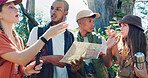 Hiking, map and discussion with friends in nature for travel destination, adventure and location. Tracking, vacation and explore with people outdoor for trekking, wilderness and eco holiday guide