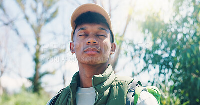Buy stock photo Man, hiking and thinking in forest, break and eyes closed on adventure, inspiration or flare in summer. Person, outdoor and reflection for perspective, memory and trekking in woods for nature tourism