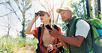 Couple, binoculars and phone for hiking in forest with sightseeing, search and digital map for direction. People, smartphone and view with mobile app, birdwatching or trekking adventure in woods