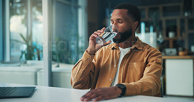 Buy stock photo Black man, drinking water and wellness with remote work from home, detox and liquid for self care with gut health. African person, glass and freelance writer with hydration, laptop and break in house
