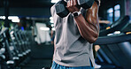 Arm, dumbbell and fitness with man in gym for bodybuilding, strength training or workout routine. Exercise, space and weightlifting with bodybuilder person in health club for physical challenge