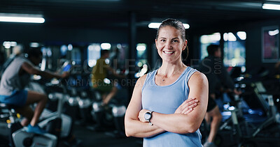 Buy stock photo Portrait, personal trainer and woman with arms crossed, gym and confident for fitness in spin class. Happy, instructor and people with bikes for health benefits, wellness and exercise on equipment