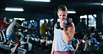 Woman, fitness and weightlifting with dumbbell in gym for strength training or muscle gain. Active, female person or lifting with weight or bicep curl for arm workout or exercise in health club