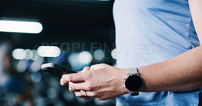 Buy stock photo Woman, hands and typing in gym with phone, workout research or notification for wellness app sign up. Bokeh, active person and scroll in health club with tech, fitness website or check exercise blog.