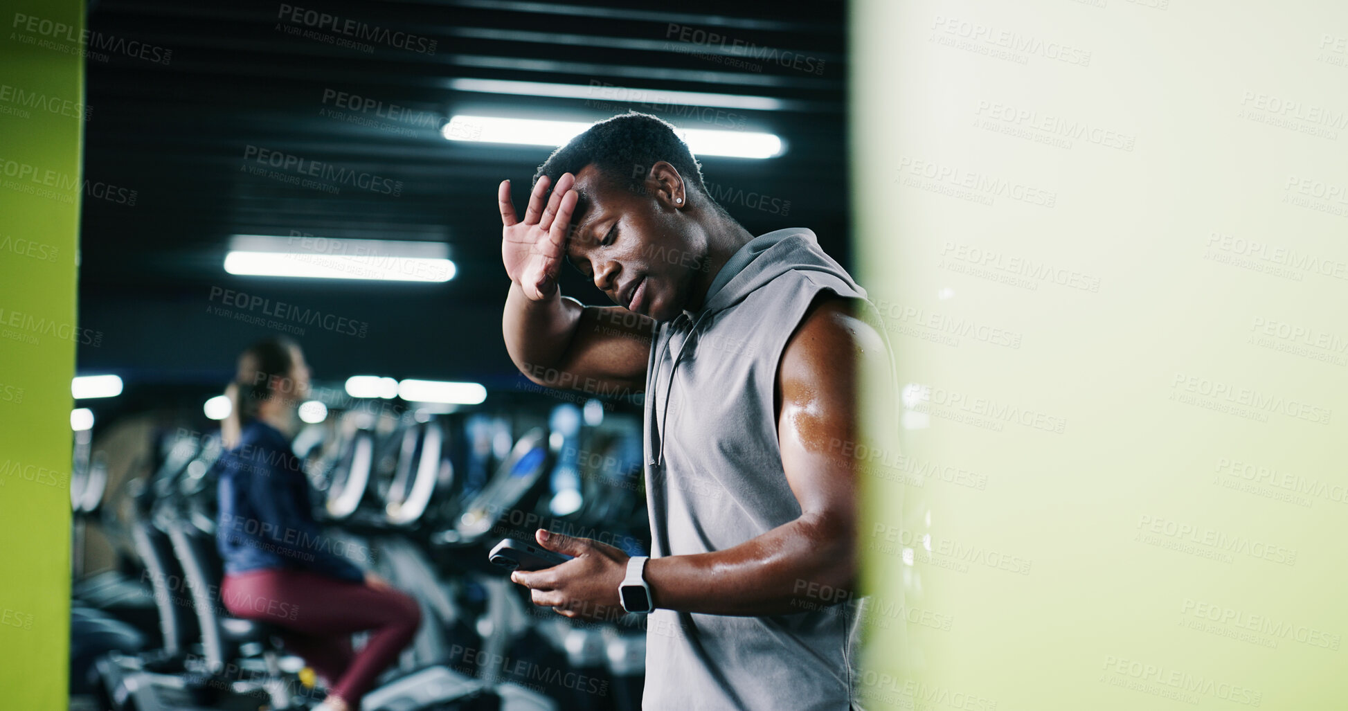Buy stock photo Man, sweating and scroll in gym with phone, workout break and notification for social media update. Space, exhausted person and tech with exercise website, internet and alert for fitness app tracker.