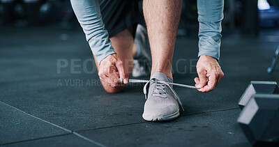 Buy stock photo Person, hands and tying with shoes for fitness, workout preparation or indoor training in gym. Closeup, active or runner getting ready with sneakers, laces or dumbbells for exercise in health club