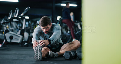 Buy stock photo Man, fitness or stretching with leg in gym for workout preparation, exercise or indoor training. Active, male person or getting ready with warm up or dumbbells on space for flexibility in health club