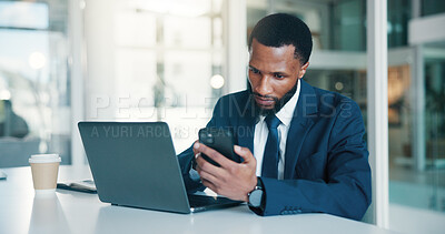 Buy stock photo Business, man and laptop with phone in office for record keeping, finance app and auditing. Accountant, black person or tech at desk for financial reporting, budget review or MFA code to track income