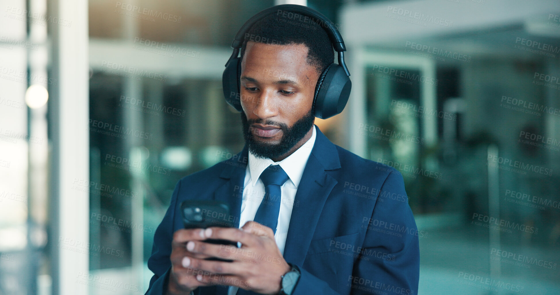 Buy stock photo Financial advisor, smartphone and black man in office, headphones or podcast for trading info. African person, employee or investor in workplace, cellphone or audio for radio or digital app for sound