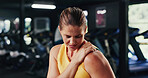 Athlete, woman and discomfort with shoulder pain at gym for fitness injury, muscle fatigue and burnout. Female person, strain and ache from poor warm up, inflammation and tendinitis with joint cramps
