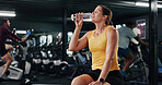 Woman, fitness and break with water bottle in gym for hydration, recovery or workout rest. Active, female person or mineral liquid with aqua beverage or drink for sustainability in health club