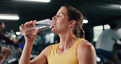 Buy stock photo Woman, fitness and drinking with water bottle in gym for hydration, recovery or workout rest. Active, female person or mineral liquid with aqua beverage for sustainability or nutrition in health club