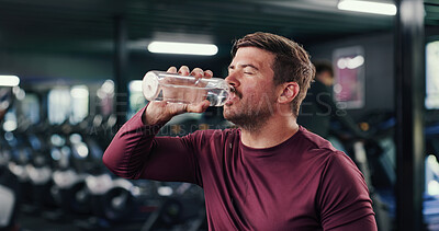 Buy stock photo Man, fitness and drinking with water bottle in gym for hydration, recovery or workout rest. Active, male person or mineral liquid with aqua beverage for sustainability or nutrition in health club