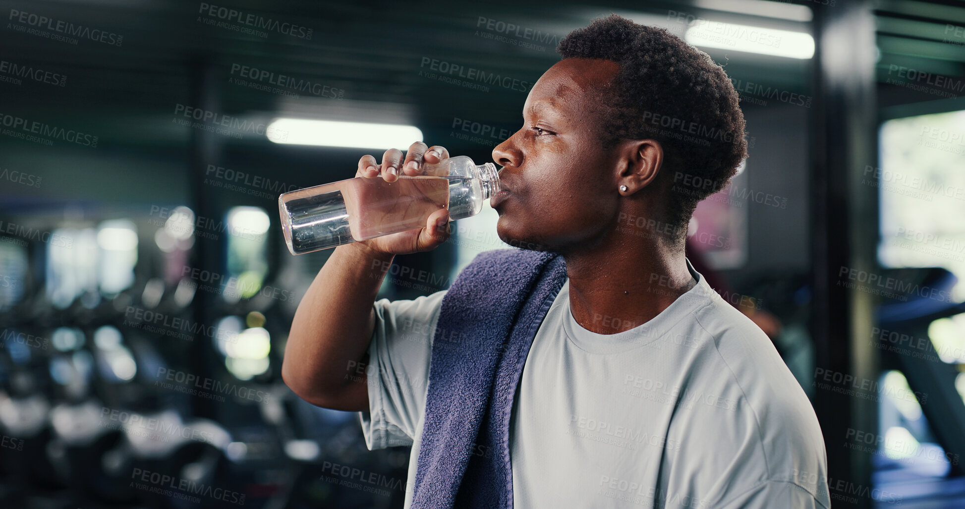 Buy stock photo Black man, fitness and drinking with water in gym for hydration, recovery or workout rest. Active, male person or mineral liquid with aqua beverage for electrolytes or nutrition in health club