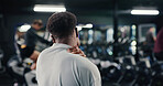 Burnout, fitness and neck pain with man in gym for training accident or workout mistake. Back injury, discomfort and space with person in health club for condition, fatigue or inflammation