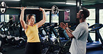 Fitness, personal trainer or woman with barbell in gym, strength challenge or coaching for body goals. Strong, instructor or people with weightlifting exercise for muscle gain, explain form or active